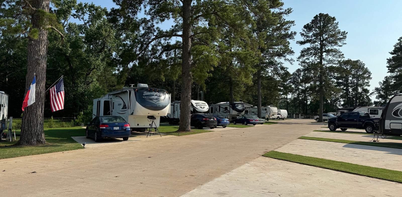Concrete roads and spacious RV sites at Hidden Lake RV Resort in Pinehurst, TX